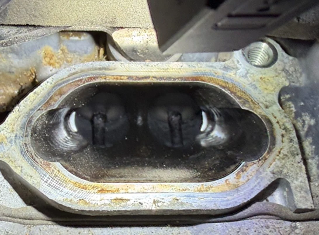 Intake port before cleaning: valves and port walls coated in black carbon